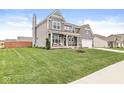 Well-maintained home featuring a spacious lawn and inviting front porch, perfect for relaxing outdoors at 474 Pekin Way, Pendleton, IN 46064