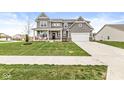Beautifully landscaped front yard showcases this lovely two-story home, complete with a cozy front porch at 474 Pekin Way, Pendleton, IN 46064