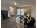 Cozy living room with modern furniture, a striped rug, and plenty of natural light at 4912 Cayman Ct, Columbus, IN 47203