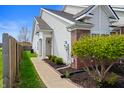 Charming home exterior with neat landscaping, a cozy walkway, and white vinyl siding at 4916 Franklin Villas Dr, Indianapolis, IN 46237