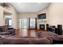 Bright living room with a fireplace, a TV, hardwood floors, and sliding glass doors to the backyard at 4916 Franklin Villas Dr, Indianapolis, IN 46237