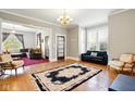 Bright living room with hardwood floors, neutral walls, and a black and light pink detailed rug at 516 S 10Th St, Noblesville, IN 46060