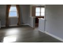 Bright living room with stylish gray walls, wood-look floors and abundant natural light through large windows at 548 S Vine St, Indianapolis, IN 46241