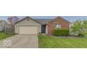 Single-Gathering home with brick and siding, attached two-car garage, and driveway at 5634 Wynridge Ct, Indianapolis, IN 46235