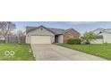 Single Gathering home with a brick and siding exterior, two-car garage and concrete driveway at 5634 Wynridge Ct, Indianapolis, IN 46235
