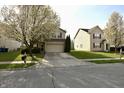 View of the home's front exterior, showcasing the lawn and curb appeal at 5828 Long Lake Ln, Indianapolis, IN 46235