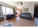 Bright living room featuring hardwood floors, a comfortable reclining sofa, and natural light at 594 Daugherty St, Columbus, IN 47201