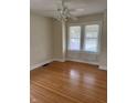 Bright bedroom with hardwood floors, ceiling fan, and double windows allowing natural light at 6186 Ralston Ave, Indianapolis, IN 46220