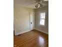Sunlit bedroom with beautiful hardwood floors, and a classic white door for easy access at 6186 Ralston Ave, Indianapolis, IN 46220