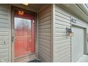 Close-up of the front door, exterior light, and house number on a townhome at 622 Conner Creek Dr, Fishers, IN 46038