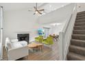 Bright living room featuring high ceilings, a fireplace, and a staircase to the second floor at 622 Conner Creek Dr, Fishers, IN 46038