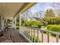 Expansive wood back deck featuring white railings and a serene view of the landscaped backyard at 7124 Purdy St, Indianapolis, IN 46268