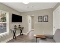 Cozy living room with neutral tones, a flat-screen TV, stylish decor, and hardwood floors at 741 Bates St, Indianapolis, IN 46202