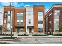 Charming townhomes with brick and siding exteriors and well-maintained landscaping along the street at 741 Bates St, Indianapolis, IN 46202