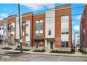 Street view of modern townhomes showcasing brick and siding facades, landscaping, and convenient parking at 741 Bates St, Indianapolis, IN 46202