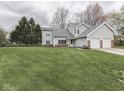Well-kept two-story home with attached two-car garage and expansive green lawn at 8160 Bold Forbes Ct, Indianapolis, IN 46217