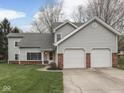 Charming two-story home featuring a two-car attached garage and large, well-manicured lawn at 8160 Bold Forbes Ct, Indianapolis, IN 46217