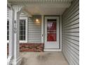 Close-up view of front door with house number, storm door, and brick accents at 8160 Bold Forbes Ct, Indianapolis, IN 46217