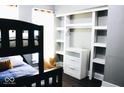 Comfortable bedroom featuring a bunk bed and custom built-in shelving unit for ample storage at 827 Dawson St, Indianapolis, IN 46203