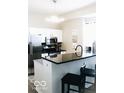 Stylish kitchen featuring stainless steel appliances, sleek black countertops, and modern lighting at 827 Dawson St, Indianapolis, IN 46203