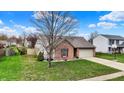 Single-story home with a well-maintained lawn and an attached two-car garage at 8312 Eagles Nest Dr, Avon, IN 46123