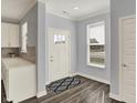 Inviting entryway featuring wood-look flooring, a stylish rug, and a bright, welcoming atmosphere at 8570 Hudson Way, Brownsburg, IN 46112
