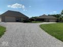 Spacious gravel driveway connects two buildings, offering ample parking and a rustic aesthetic at 8890 N Pennington Rd, Mooresville, IN 46158