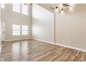 Bright living room boasting soaring ceilings, large windows, and stylish wood laminate flooring at 9763 Rolling Plain Dr, Noblesville, IN 46060