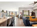 Open concept living space with bar seating, hardwood floors, and a seamless flow into other areas at 9847 Bryce Blvd, Pendleton, IN 46064