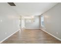 Bright living room with light gray walls, modern light-colored flooring, and ample natural light at 10861 Tealpoint Dr, Indianapolis, IN 46229