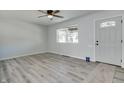 Bright, open living room with hardwood floors, fresh paint, modern ceiling fan, and ample natural light at 1125 N Colorado Ave, Indianapolis, IN 46201