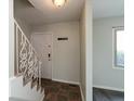 Cozy entryway featuring decorative stair railing, tiled floor, and coat hooks by the front door at 1131 Canterbury S Sq, Indianapolis, IN 46260