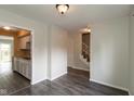 Open concept living space with wood-look floors and seamless transition to the entry and kitchen at 1131 Canterbury S Sq, Indianapolis, IN 46260