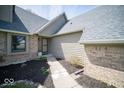 Welcoming entrance with a brick facade and landscaped walkway, leading to a cozy front door at 11525 Capistrano Cir, Indianapolis, IN 46236