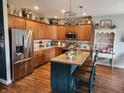 Beautiful kitchen featuring stainless steel appliances, center island, and stylish lighting at 1302 Country Creek Cir, Shelbyville, IN 46176
