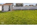 Spacious backyard featuring a shed, garden beds, and lush green grass at 1305 Bontrager Ln, Shelbyville, IN 46176