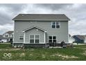 A spacious backyard featuring well-maintained vinyl siding and a cozy patio area at 1573 Vera Blvd, Danville, IN 46122