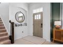 Bright foyer featuring a round mirror, staircase, and stylish decor at 1614 Waterleaf Dr, Westfield, IN 46074