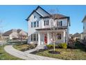 Stylish two-story home with white siding and manicured front yard and walkway at 1614 Waterleaf Dr, Westfield, IN 46074