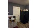 Features a white oven stove next to a black refrigerator, set against gray walls and wood flooring at 1710 Thaddeus St, Indianapolis, IN 46203