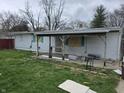 Image of a backyard featuring a covered patio and modest home with white siding at 1830 S Chester Ave, Indianapolis, IN 46203