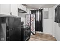 Stylish kitchen featuring a black range stove, modern cabinets, and sleek, easy-to-clean flooring at 1842 W Kessler Blvd N Dr, Indianapolis, IN 46228