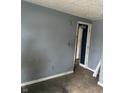 A bedroom with dark blue walls and a door to another room at 205 S 8Th St, Noblesville, IN 46060