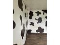 An unusual room with black and white cow print walls at 205 S 8Th St, Noblesville, IN 46060
