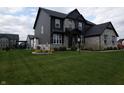 Eye-level view of a gray stone and siding home with professional landscaping at 2280 Meadow Crk, Avon, IN 46123