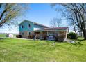 Spacious home with a large yard, showcasing the exterior with its well-kept lawn and ample space at 2372 S 300 E, Anderson, IN 46017