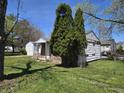 View of home with lush landscaping surrounding exterior, highlighting the serene setting at 2950 Denison St, Indianapolis, IN 46241