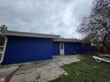 Home with blue siding and a concrete patio, perfect for outdoor relaxation and entertaining at 3162 Wallace Ave, Indianapolis, IN 46218