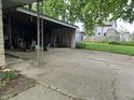 Spacious detached garage with ample storage and a long, paved driveway at 3250 Hillcrest Dr, Columbus, IN 47203