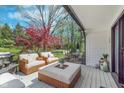 Outdoor deck featuring wicker patio furniture and view of landscaped backyard at 333 S 4Th St, Zionsville, IN 46077